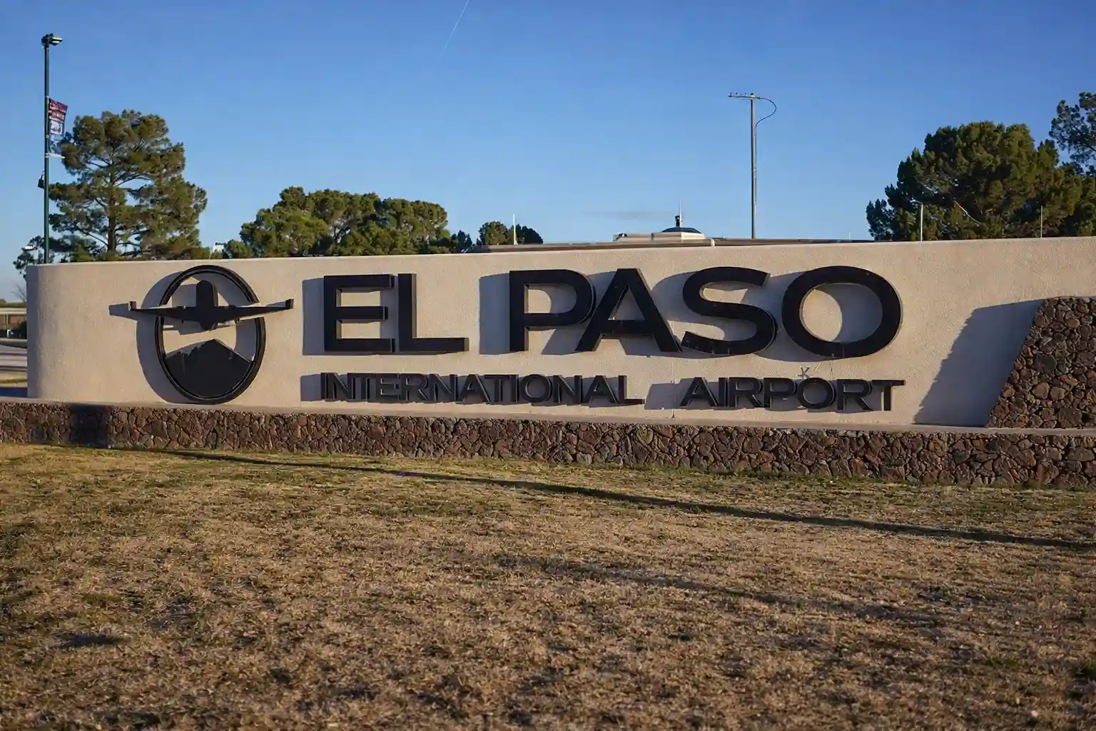 El Paso International Airport entrance sign under clear skies in Texas
