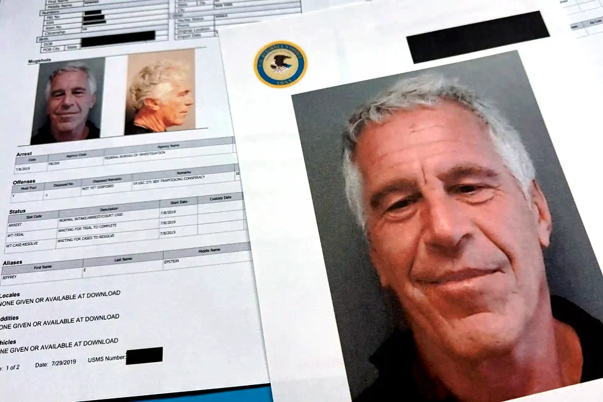 Printed federal documents displaying mugshots and case information related to Jeffrey Epstein.