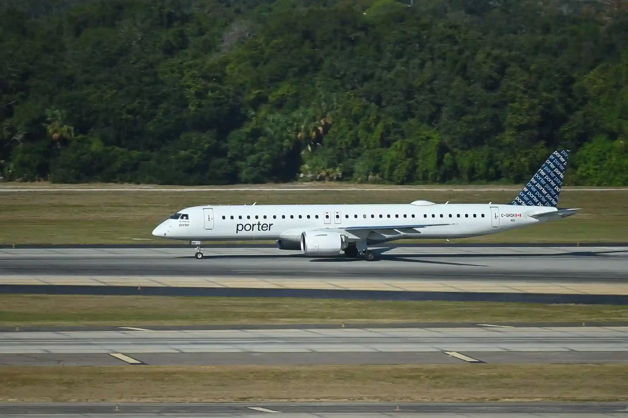 A Porter Airlines plane landing on the runway, showing the aircraft in motion during takeoff or landing