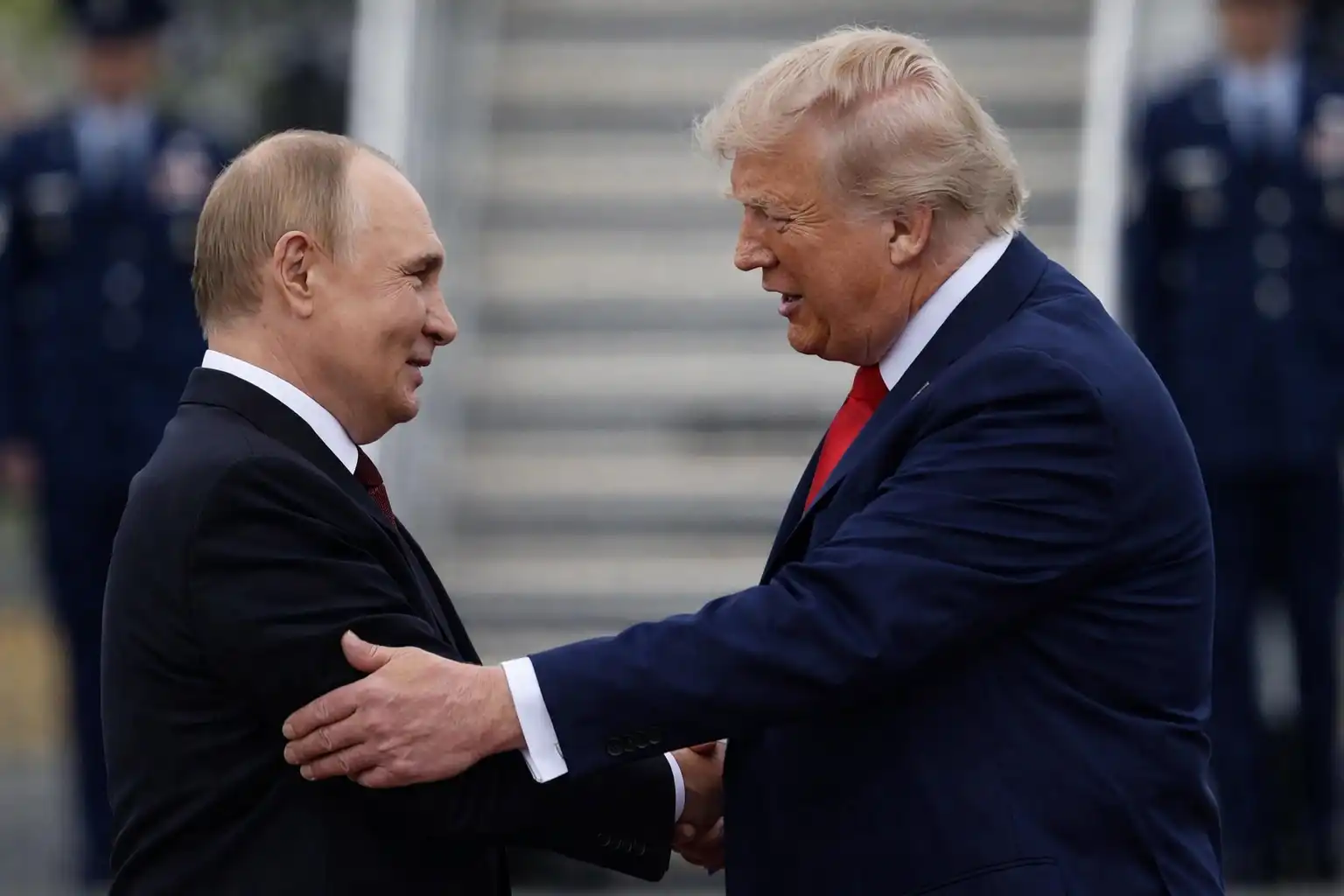 Russian President Vladimir Putin shaking hands with former President Donald Trump during a diplomatic meeting.