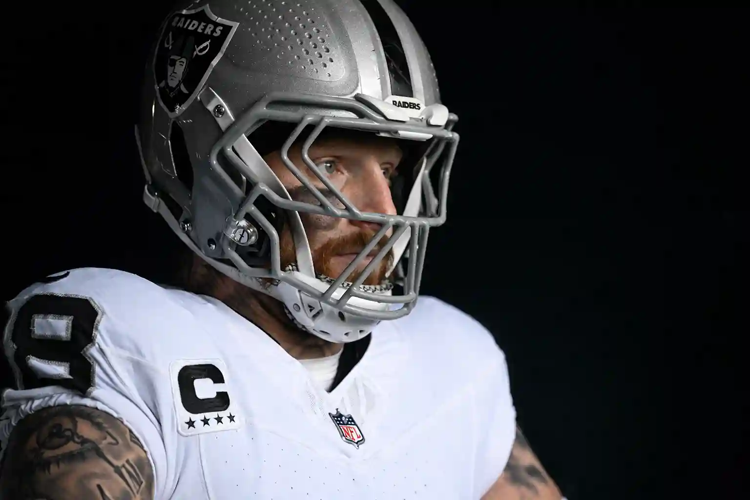 Las Vegas Raiders defensive end Maxx Crosby in helmet and uniform before an NFL game amid Baltimore Ravens trade collapse news.