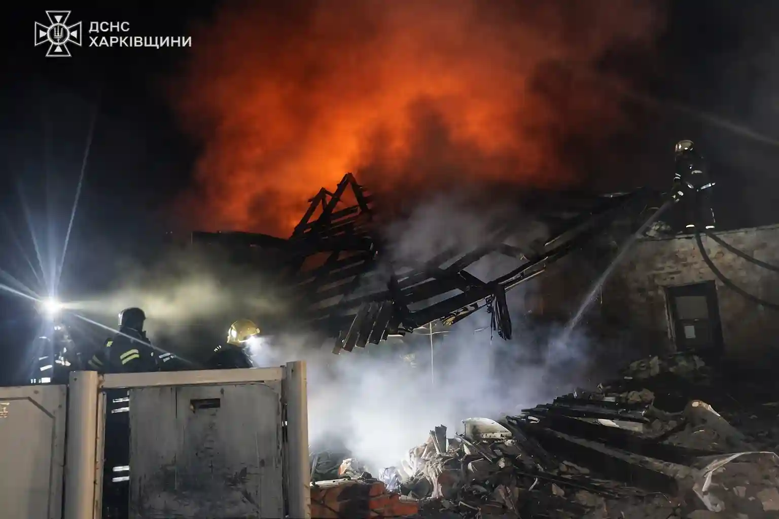 Emergency crews battle flames and search rubble after Russian drone strike destroyed a home in Kharkiv region.