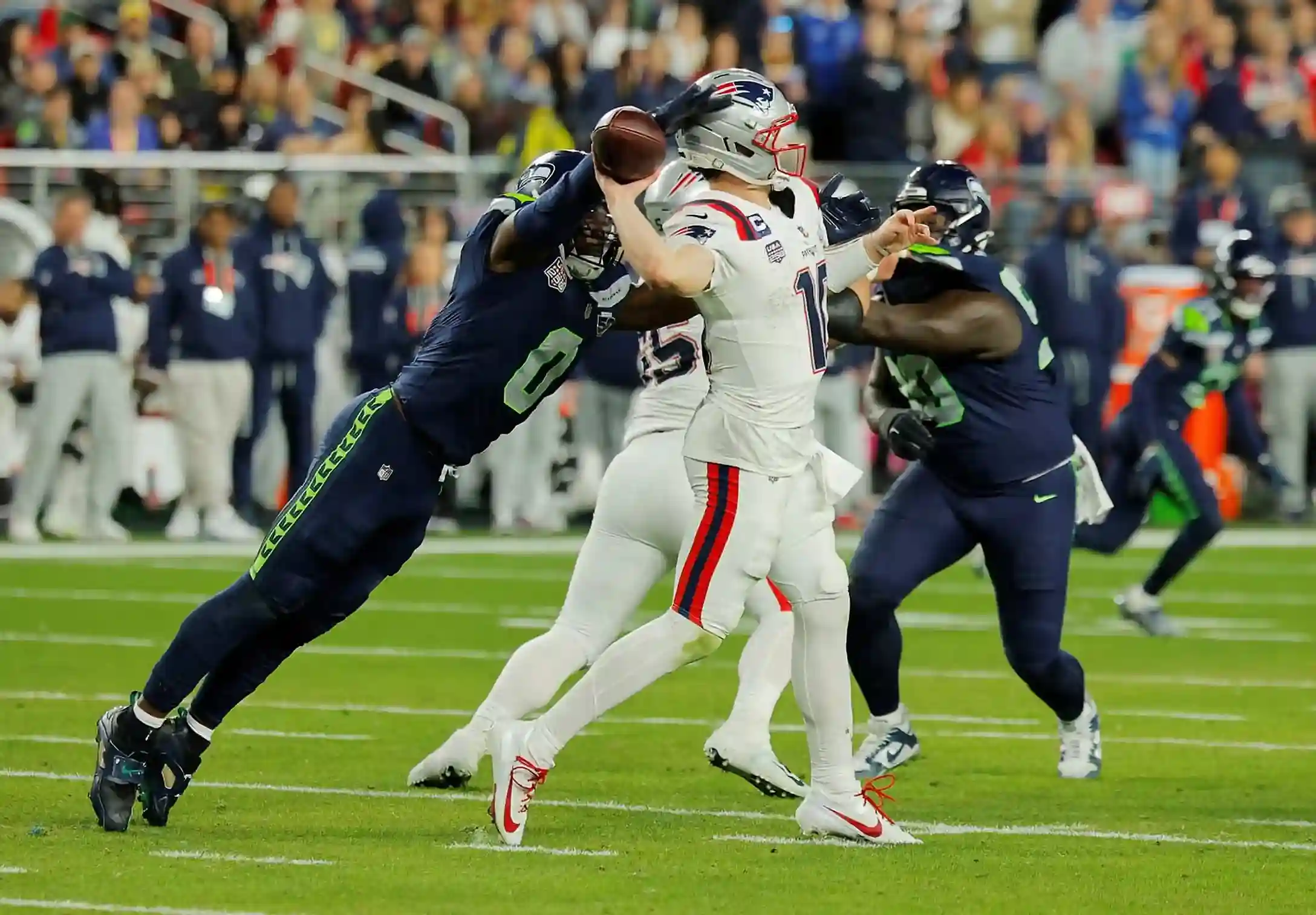 Seattle Seahawks defenders sack New England Patriots quarterback as he attempts a pass during Super Bowl LX