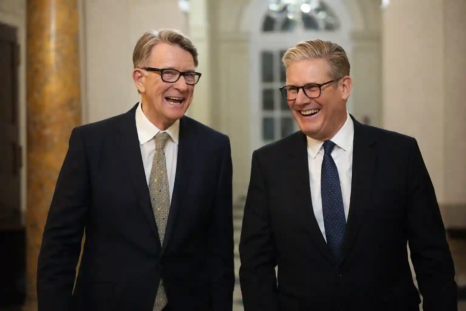 Keir Starmer and Peter Mandelson sharing a laugh, photographed together, in a formal setting.
