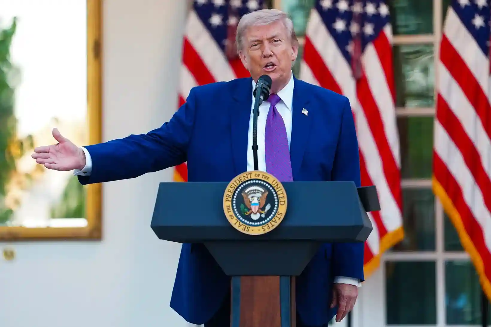 Donald Trump in the White House Situation Room with Gulf leaders and military maps showing the Strait of Hormuz and regional military deployments